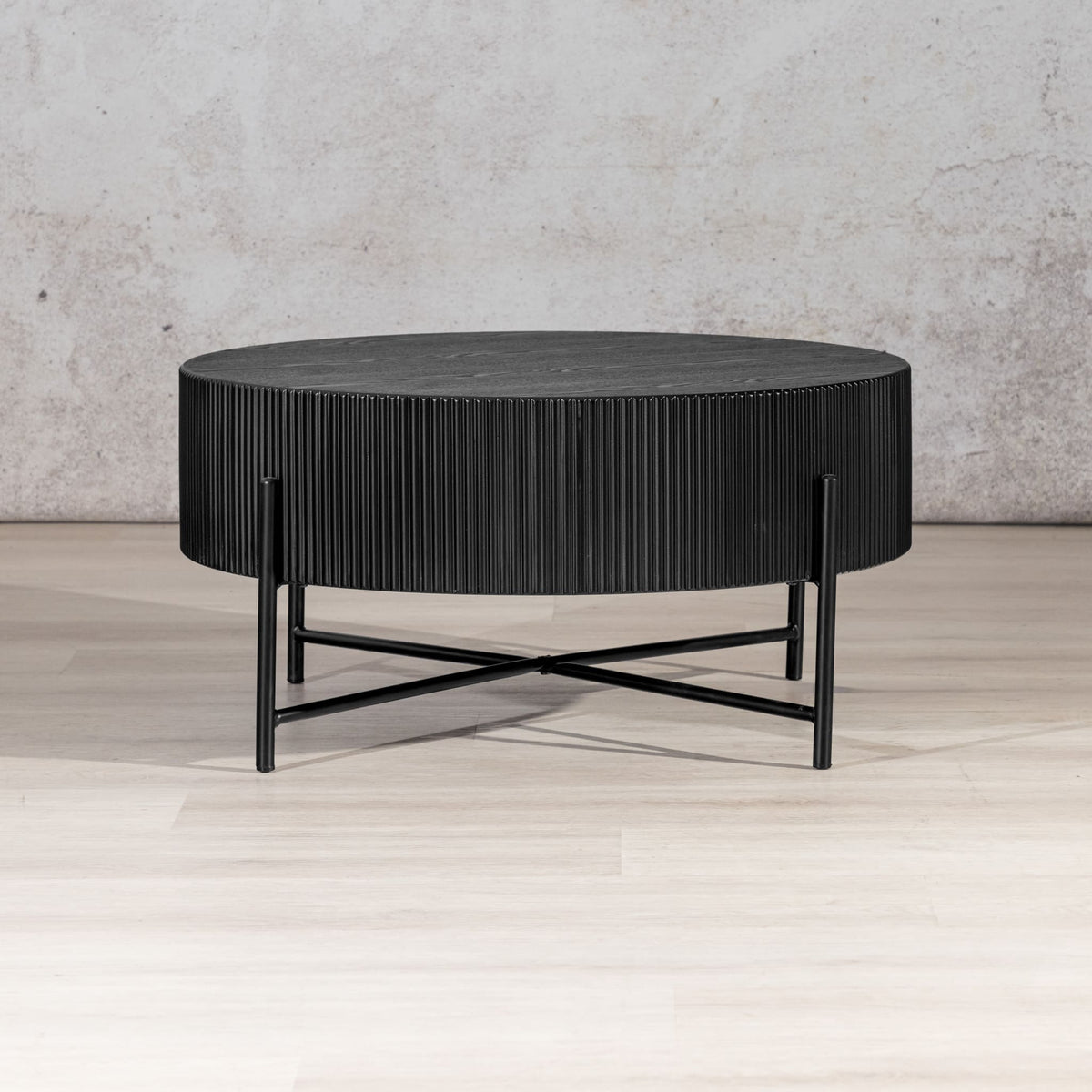 Armstrong black round coffee table with ribbed texture and X-frame base. | coffee tables, modern coffee table, black coffee table
