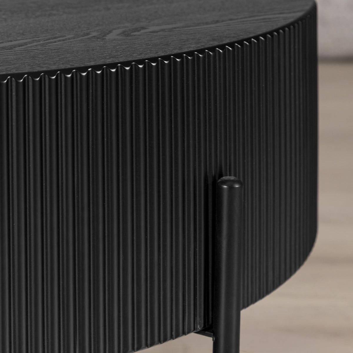 Side profile of Armstrong black coffee table showing ribbed wood-grain texture. | round coffee table, wood coffee table