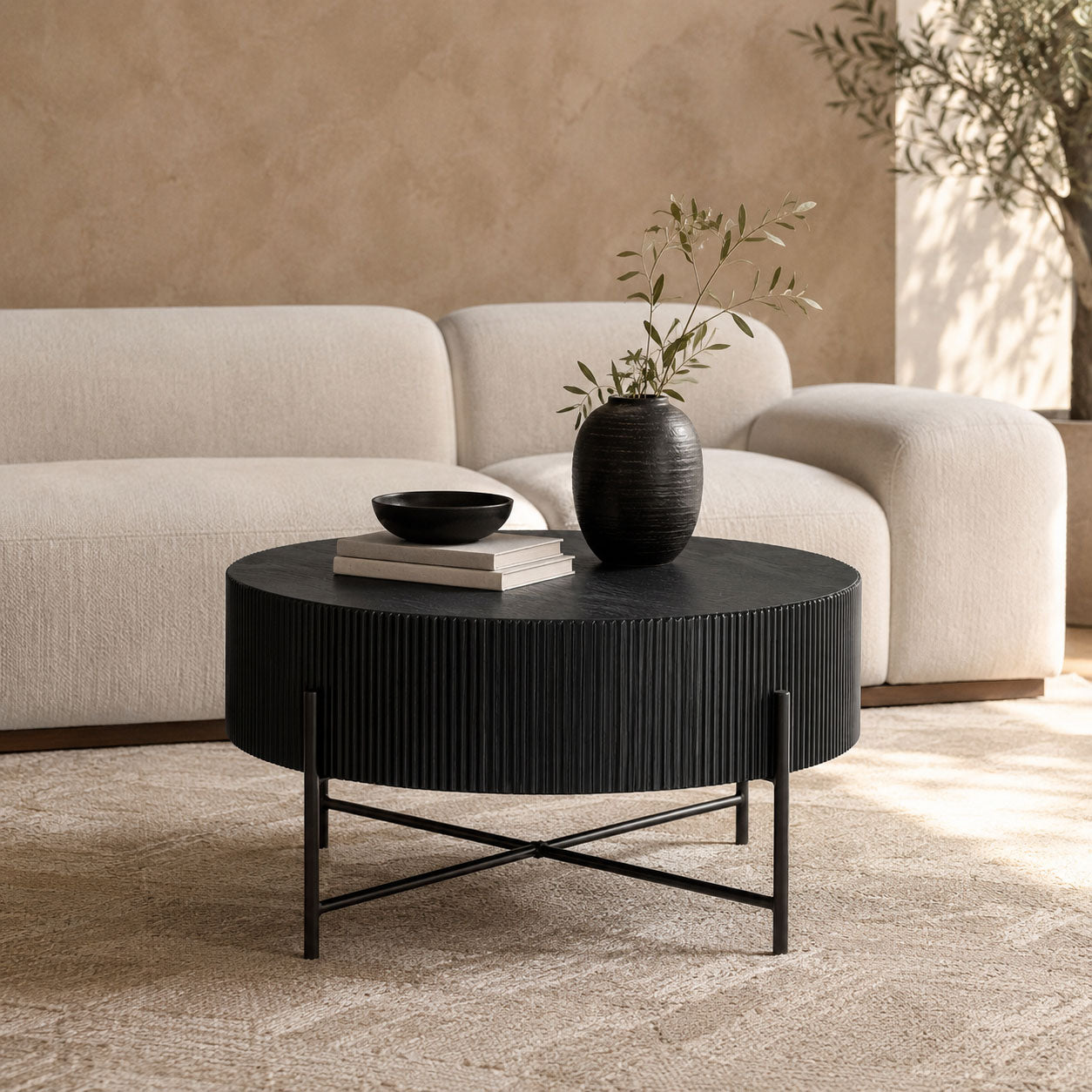 Armstrong black coffee table with X-frame metal legs styled in a modern living room. | coffee tables, round coffee table, wood coffee table 