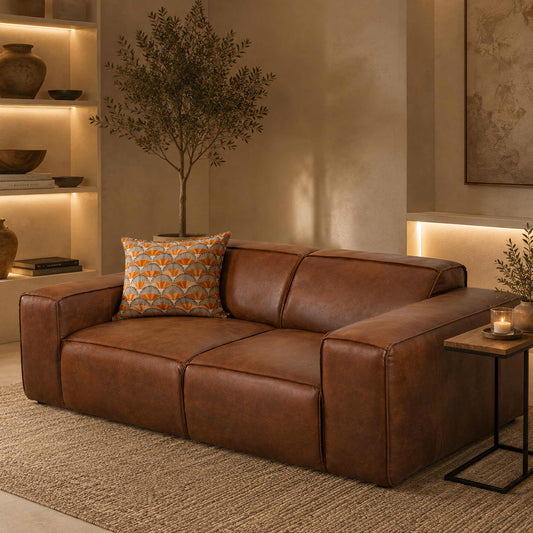 Leather Gallery Austin 3 Seater Leather Couch in Woodlands Spice, styled in a warm modern living room with a patterned cushion and side table.
