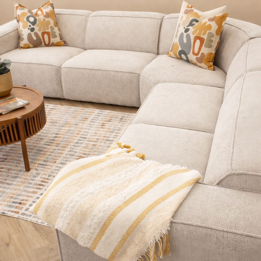 Top view of the Austin Fabric Sectional in Belle Beige paired with a stylish Turkish rug and matching scatter cushions. 