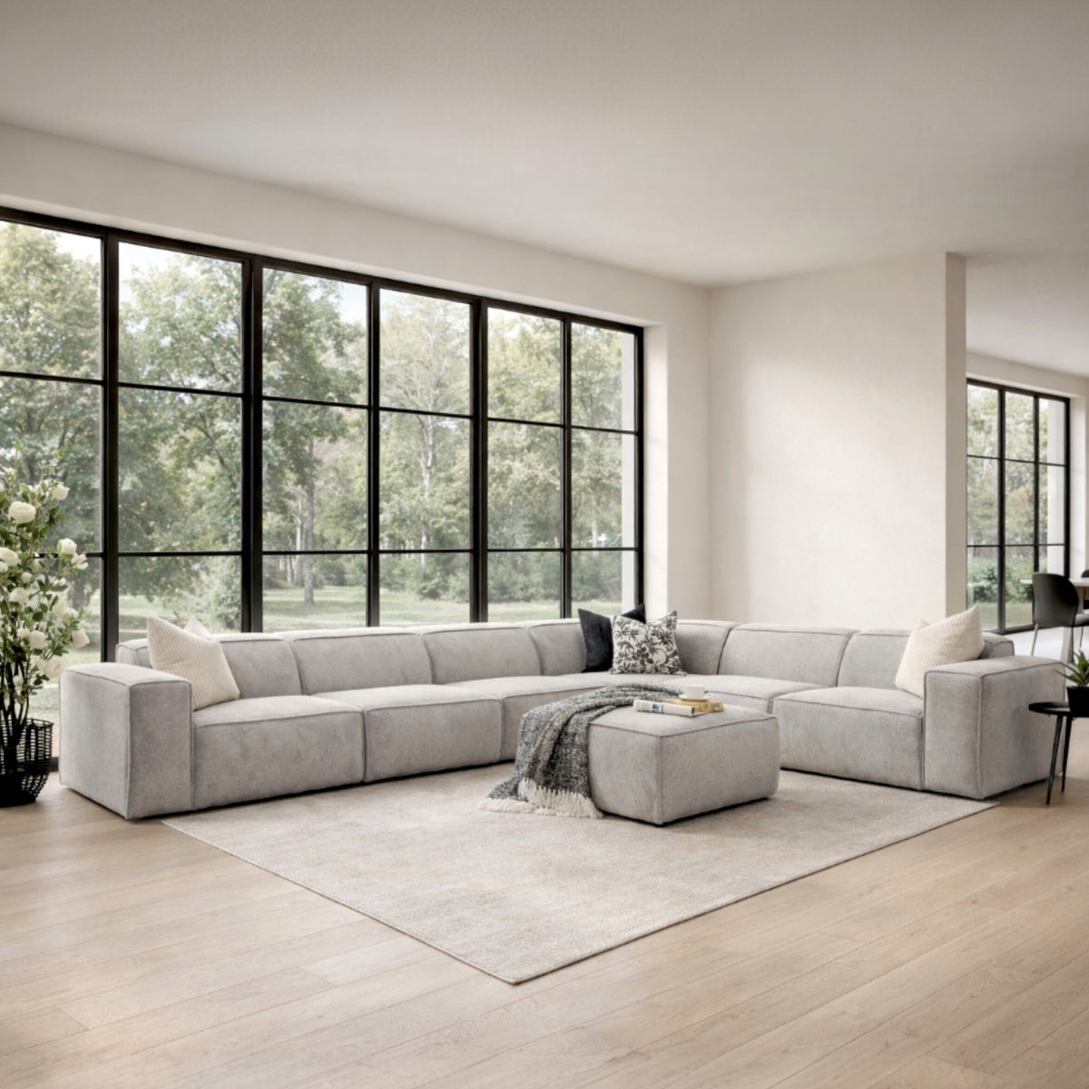 Austin Fabric L-sectional 6-seater Couch - Bordeaux Grey in an airy living space with black and white décor accents | Luxury Couches, modular sectional couch, fabric couches, l shaped couches 