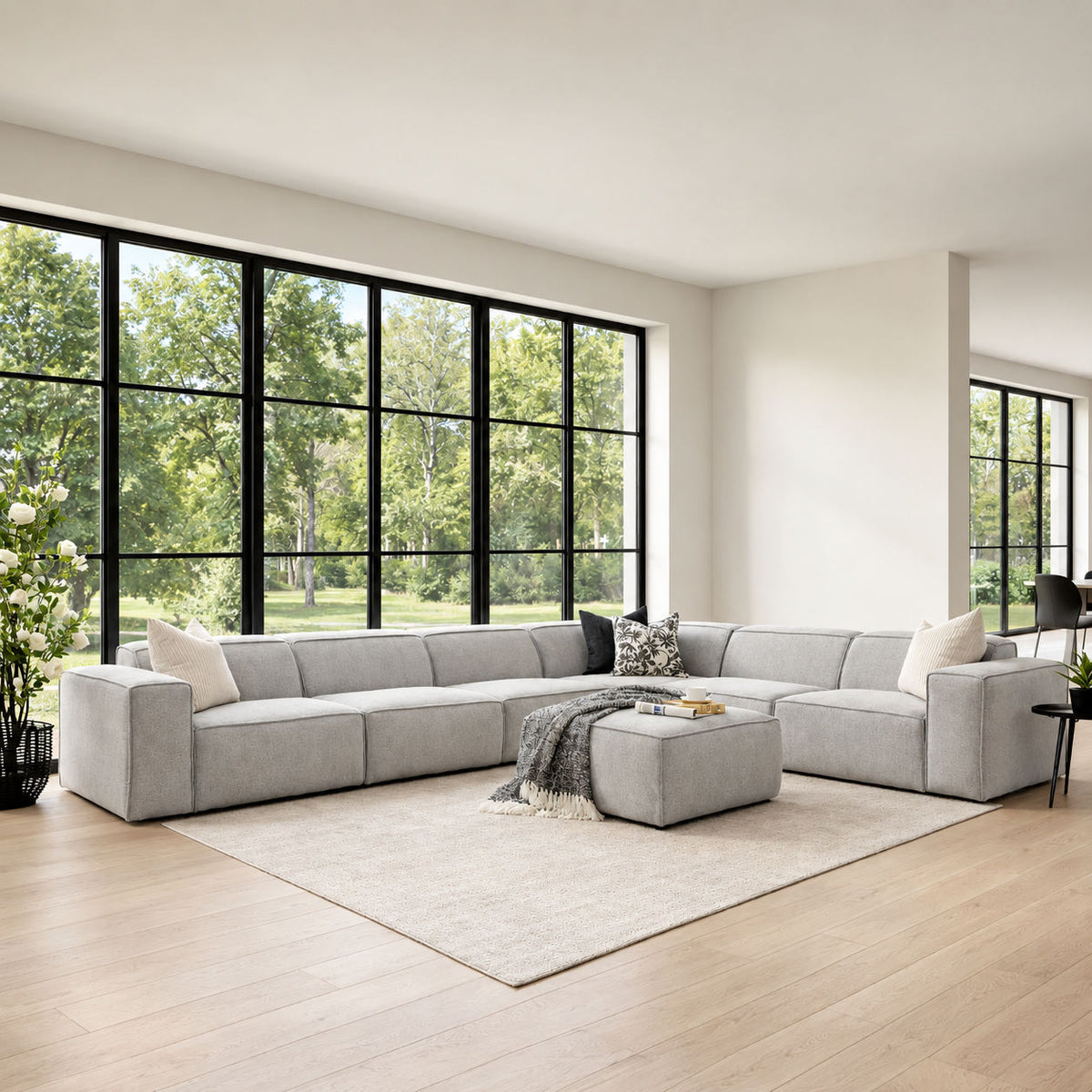 Austin Fabric L-sectional 6-seater Couch - Bordeaux Grey in an airy living space with black and white décor accents | Luxury Couches, modular sectional couch, fabric couches, l shaped couches 