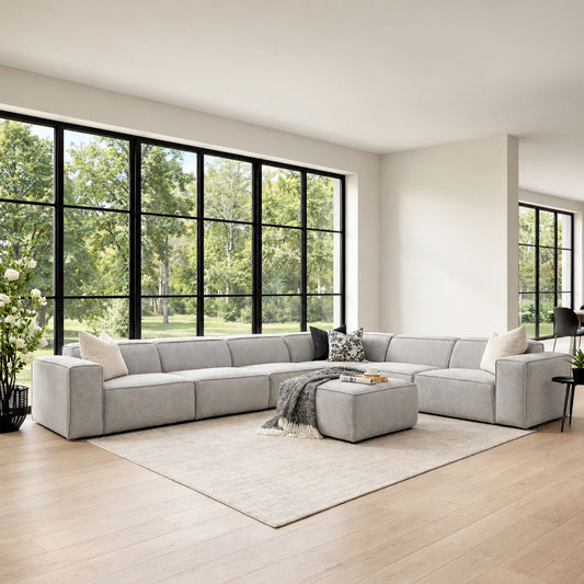 Austin Fabric L-sectional 6-seater Couch - Bordeaux Grey in an airy living space with black and white décor accents | Luxury Couches, modular sectional couch, fabric couches, l shaped couches 