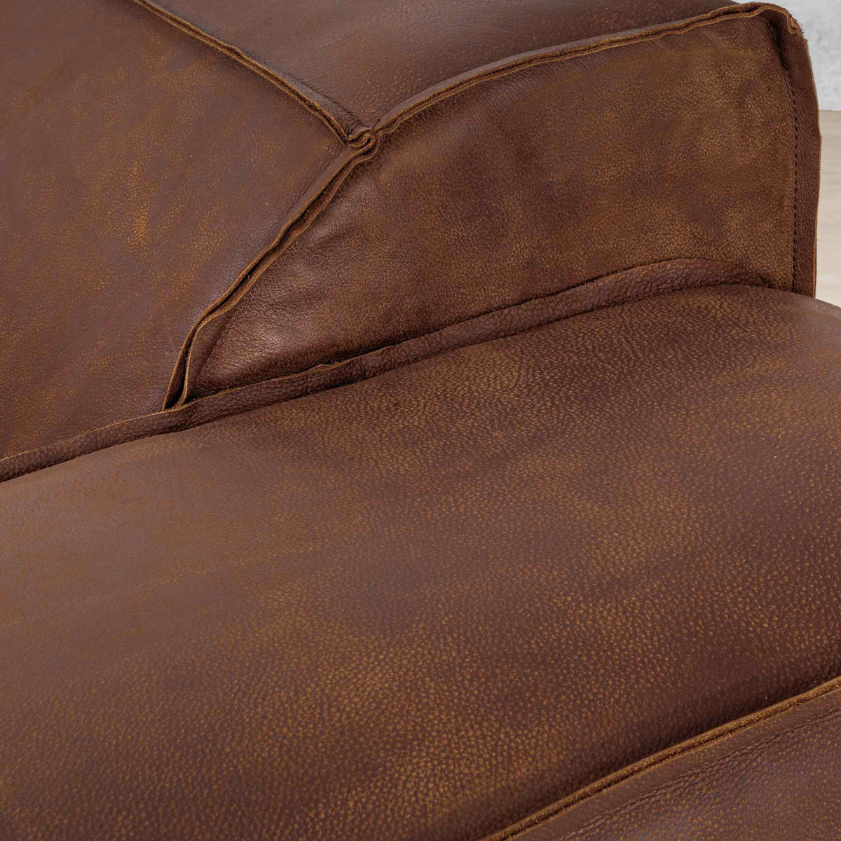 Austin Close up Leather Couch  in Woodlands Spice, in a bright, modern-minimalist styled living room. Genuine leather couches. 