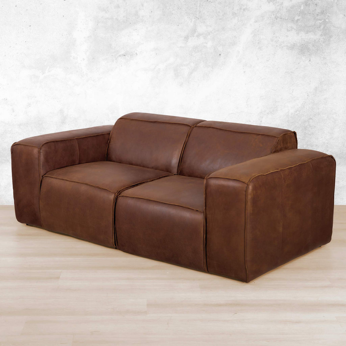 Austin 2 Seater Leather Couch  in Woodlands Spice, in a bright, modern-minimalist styled living room. Genuine leather couches. Woodlands Spice