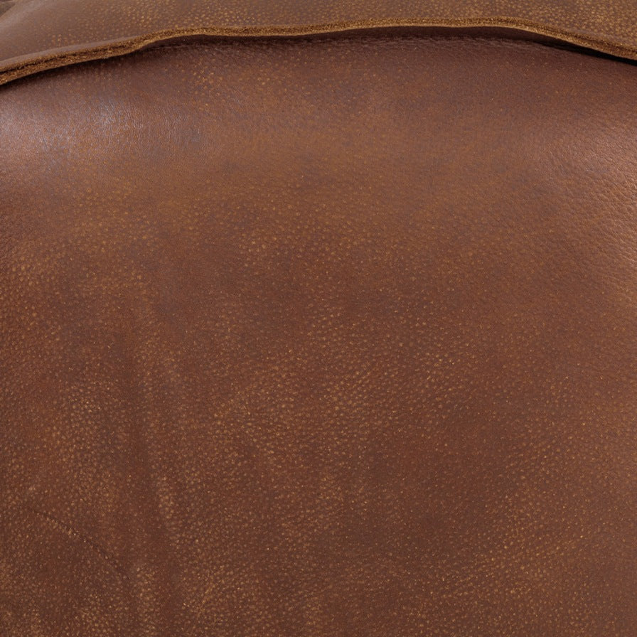 Close-up of the Leather Gallery Austin Leather Ottoman in Woodlands Spice, showing the rich brown leather texture and natural grain.