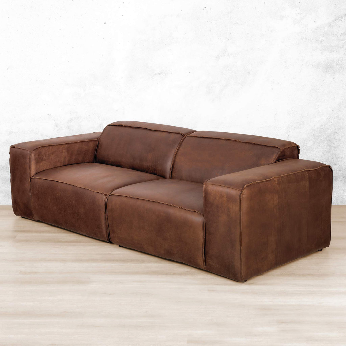 Austin 3 Seater Leather Couch in Woodlands Spice, in a bright, modern-minimalist styled living room. Genuine leather couches.  