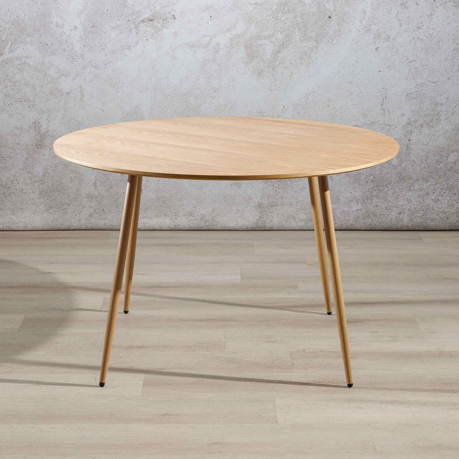Beckett 4 seater dining table in natural wood with tapered wood legs, front view. | round dining table, 4 seater dining table, dining room table
