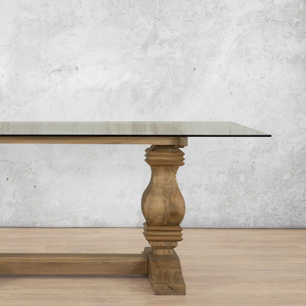 Close-up view of the Belmont Glass Top Dining Table – 2.4m / 8-10 Seater, showcasing the elegant craftsmanship and clear glass top. | Leather Gallery-antique-natural-oak