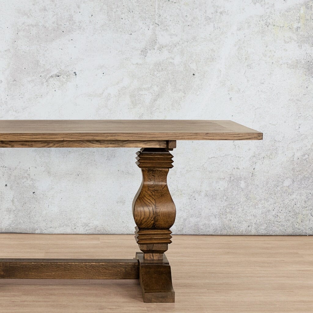 Close-up view of the Belmont Wood Top Dining Table – 6 Seater in Antique Dark Oak, showcasing the wood texture and sleek design of the table’s top. Leather Gallery antique dark oak