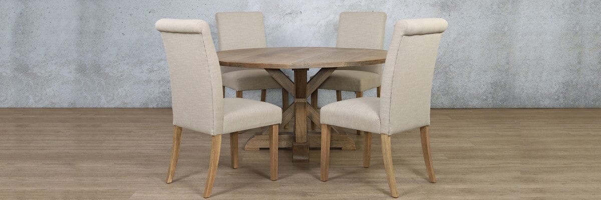Stylish 4 seater dining room set styled in a breakfast nook with round wooden table and studded chairs.