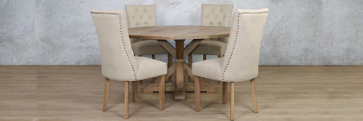 Antique Natural Oak small 4 seater dining table styled in a cosy breakfast nook with curved armrest chairs. 