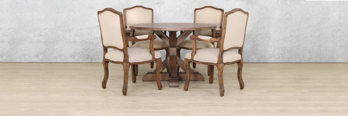 Elegant 4 seater round dining table with solid Oakwood construction, featuring a sculptural X-base and paired with matching Duke dining chairs for a timeless, traditional look.