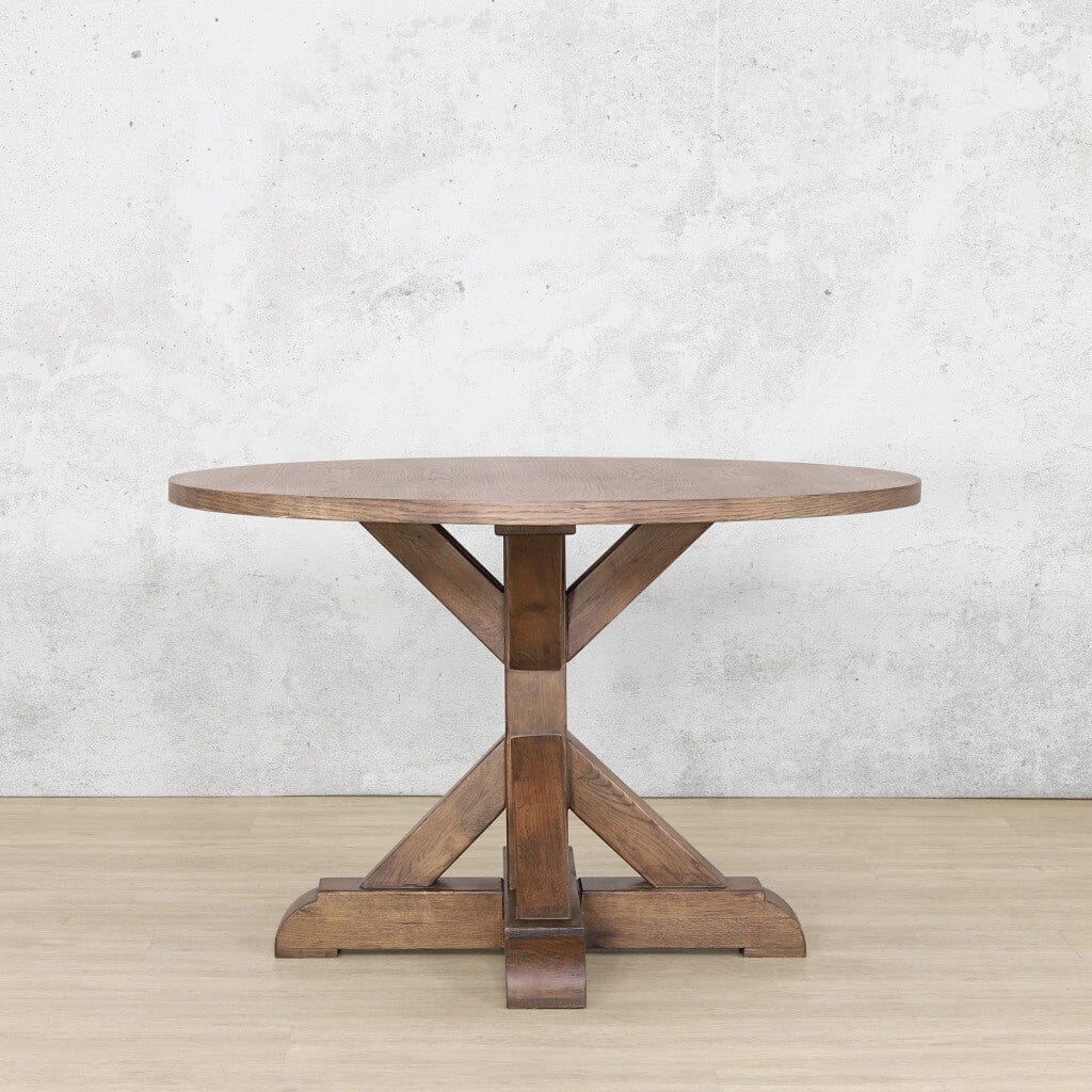 Classic round wooden dining table 4 seater with sturdy legs and a rich antique dark oak finish.