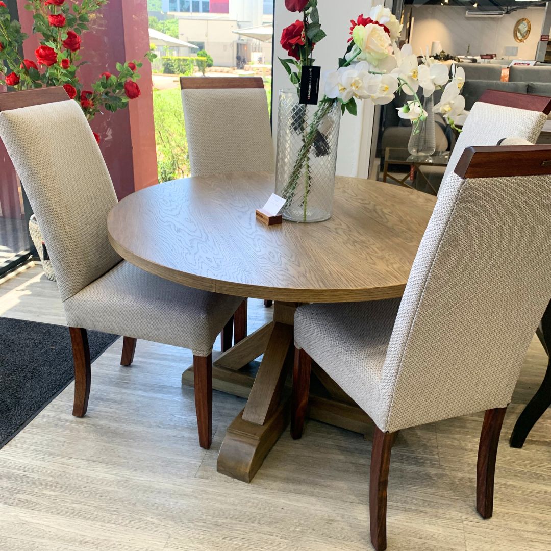 Berkeley Round Dining Table and Urban dining chair positioned at the head of a dining table, adding glamour and sophistication to the space. 