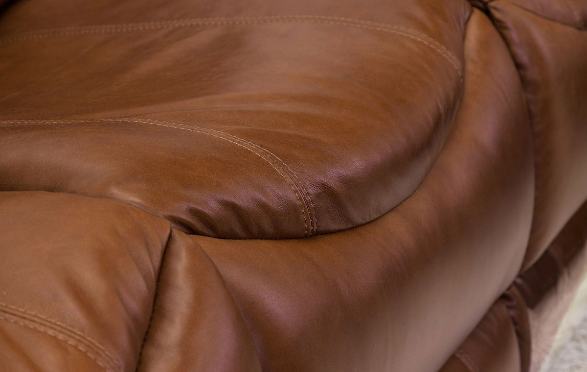 Close-up view of the bucket-style seat design on a Geneva leather recliner couch. | recliner couches, leather recliner, three seater couch, brown leather couch