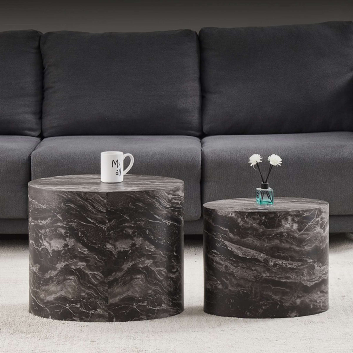 Gallery Everyday Callaway Coffee Table Set of 2, featuring marble tops styled with a cup and vase in front of a grey sofa.