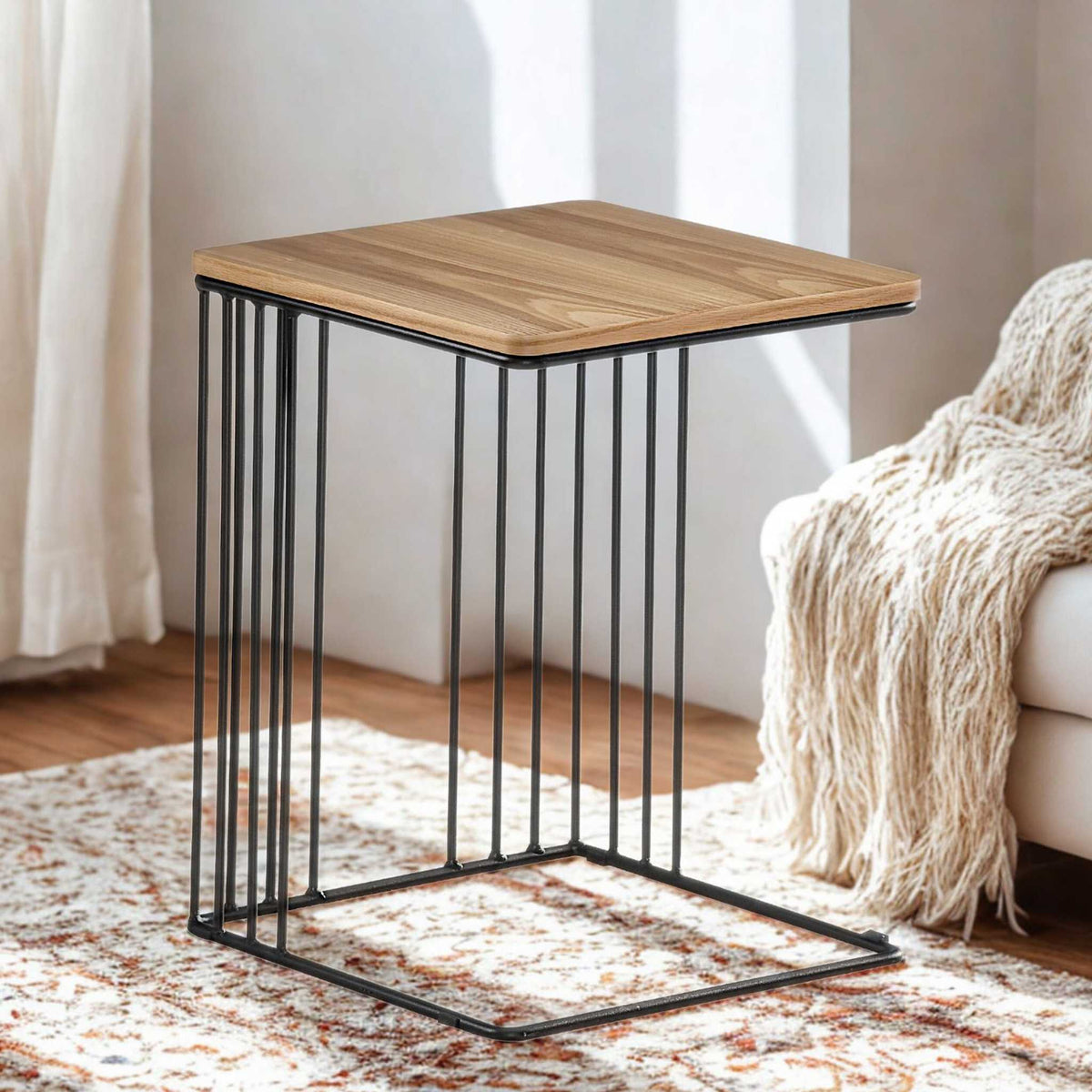 Gallery Everyday Camila Side Table in Natural, featuring a wooden top and black metal legs in a modern living room.