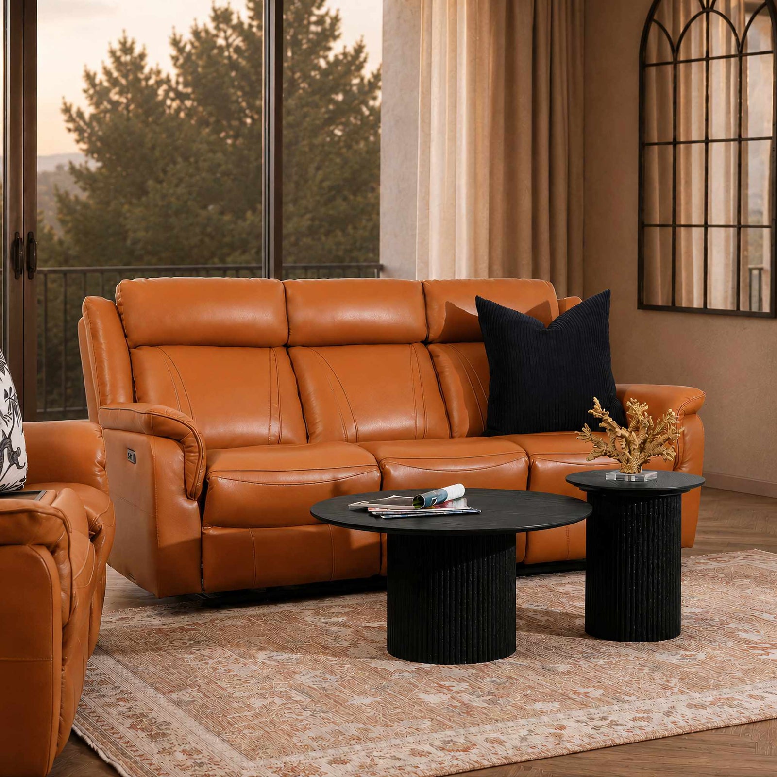 Leather Gallery Carter 3 Seater Leather Recliner in Tan, styled in a modern living room with a black cushion, coffee tables, and beige rug.