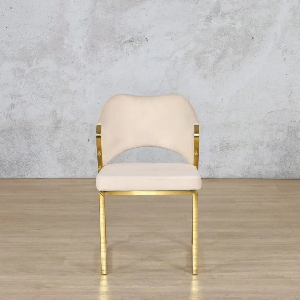 Gold dining chair positioned at the head of a dining table, adding glamour and sophistication to the space. 