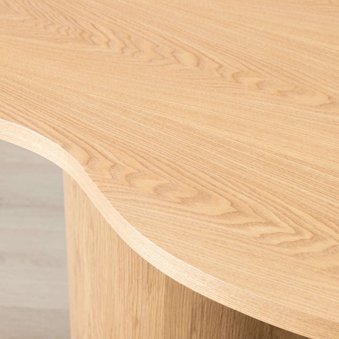 Close-up of Elodie natural dining table's curved organic edge and cylindrical wood leg. | dining room table, 4 seater dining table, wood dining table