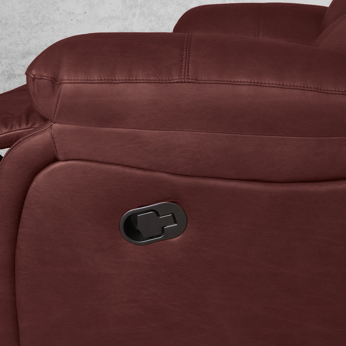 Close up of the Kuta 2 seater leather home theatre recliner in Czar Ruby, showing the recliner lever. | recliners, leather recliner, recliner couches
