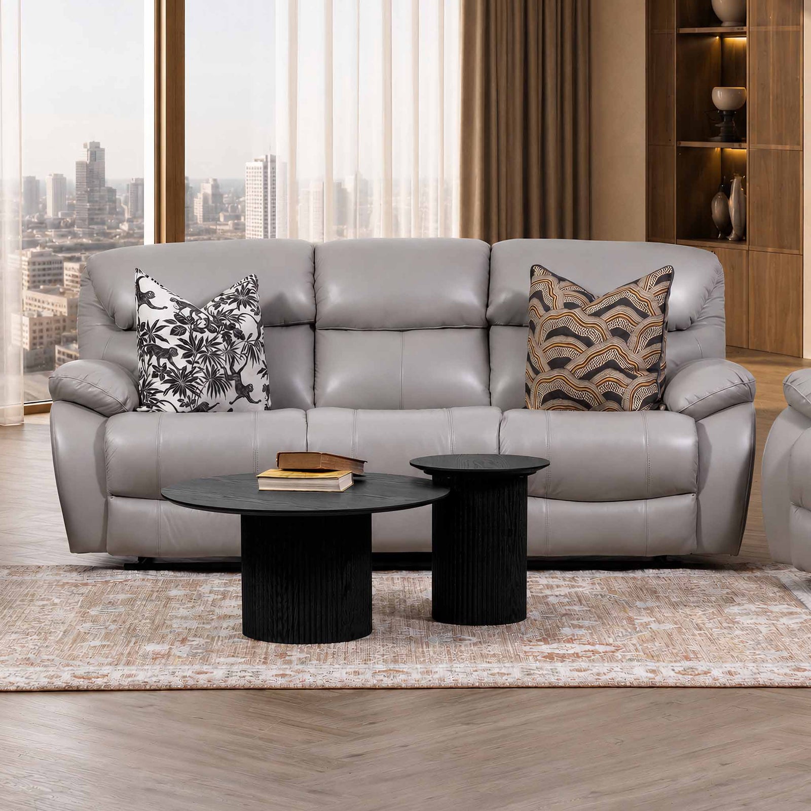 Leather Gallery Delta 3 Seater Leather Recliner in Manatee Grey, styled with patterned cushions in a modern living room.