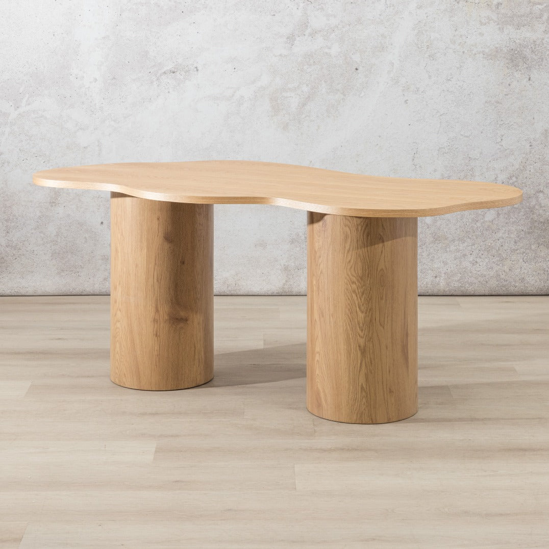 Elodie 4 seater dining table with organic free-form wood top and cylindrical pedestal legs in a natural colour | dining tables, wavy dining table, 4 seater dining table, wood dining table