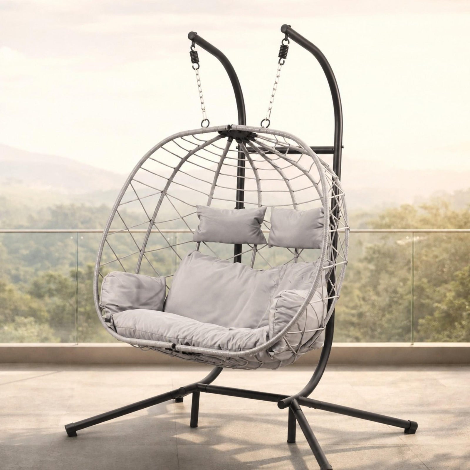Spacious two-seater Emerson Hanging Egg Chair in grey, shown in a luxurious outdoor space. | Outdoor chairs, patio chairs for sale, hanging chair, egg chairs 