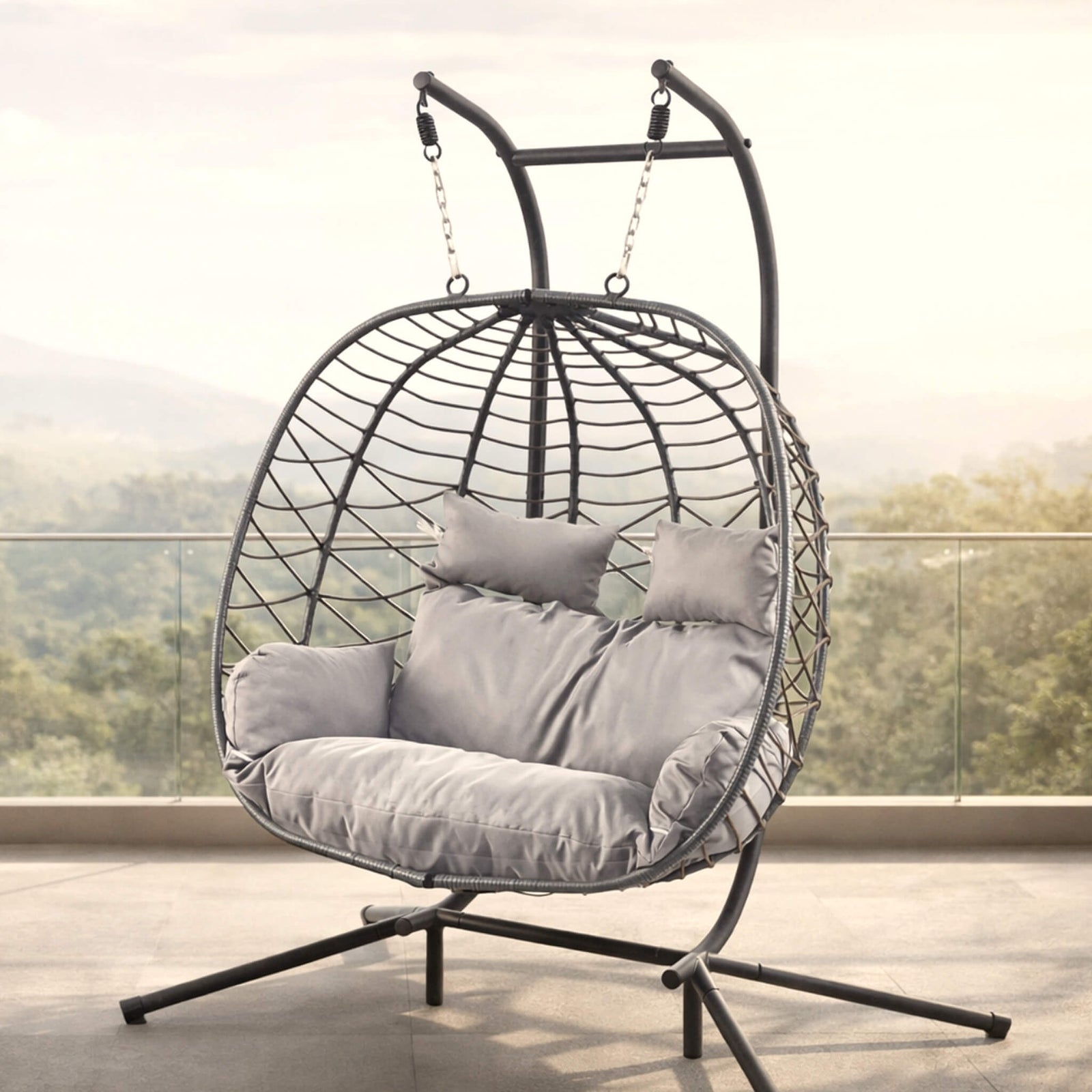 Spacious two-seater Emerson Hanging Egg Chair in grey, shown in a luxurious outdoor space. | Outdoor chairs, patio chairs for sale, hanging chair, egg chairs 