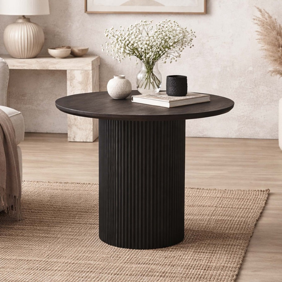 Helmsley Coffee Table, an elegant black, round wood coffee table shown in a chic lounge interior. | coffee tables, coffee tables for sale, round coffee tables 