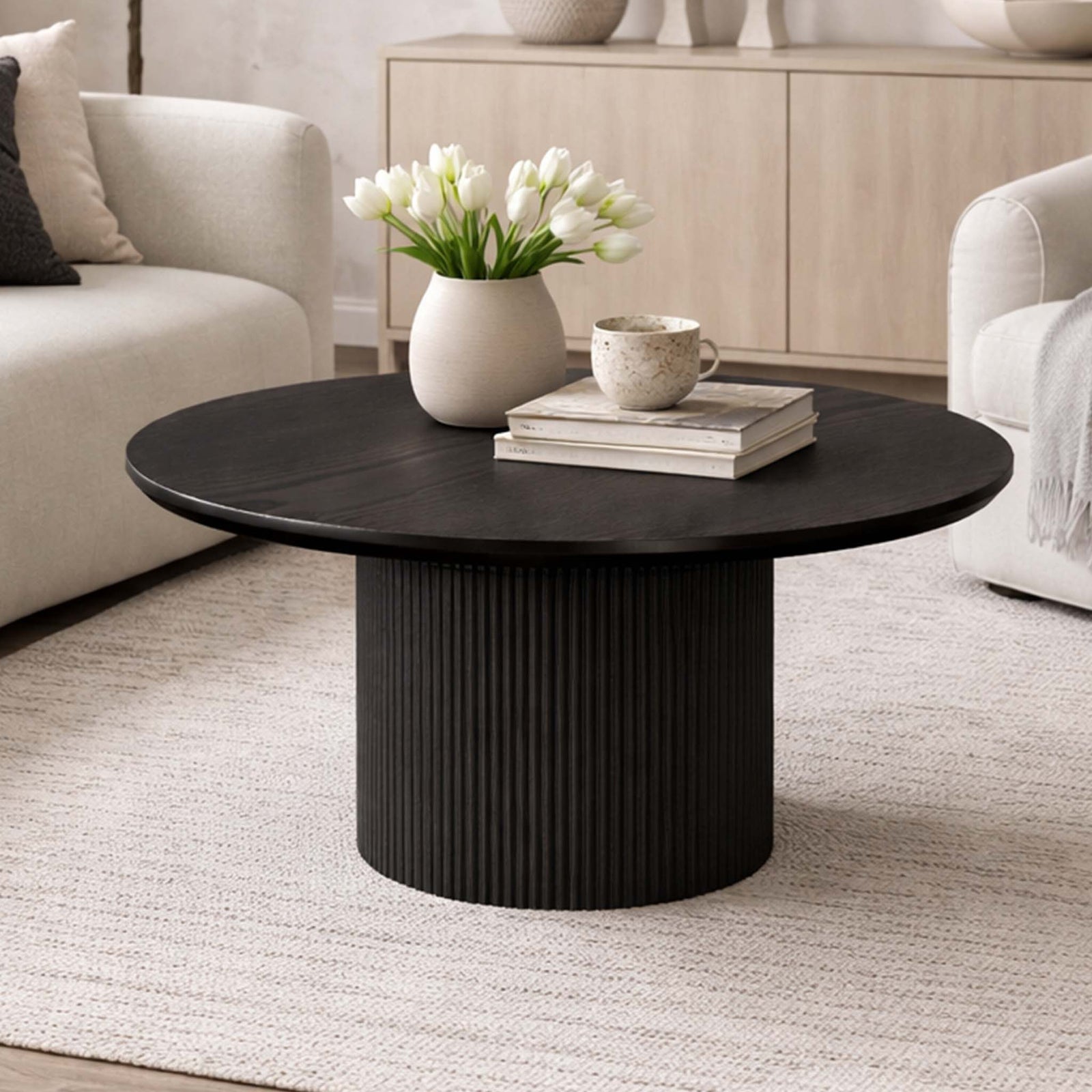 Helmsley Wood Coffee Table, in black, shown in a luxe lounge set up. | Coffee tables, round coffee tables, wood coffee table, coffee tables for sale 