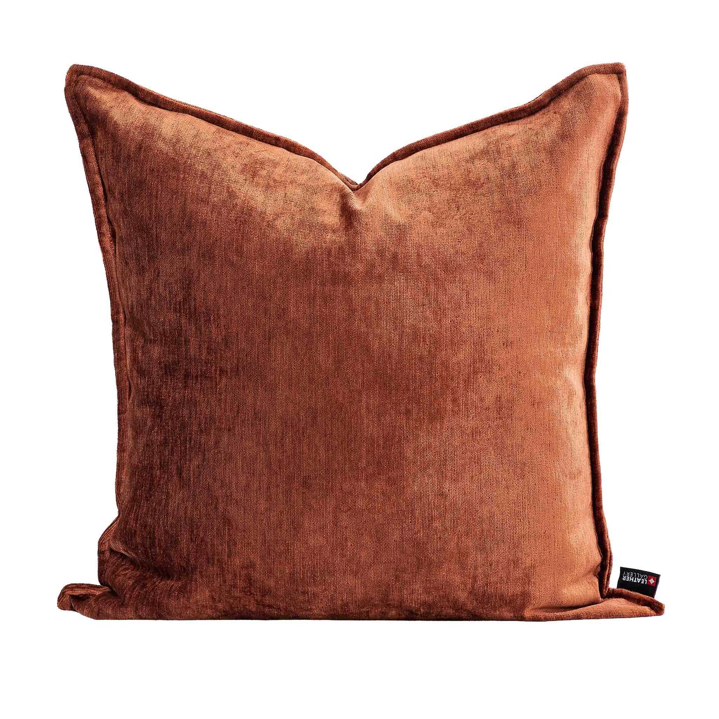 Leather Gallery Vista Plateau Cushion in Burnt Clay, featuring rich rust-brown velvet with piped edges and a branded tag.