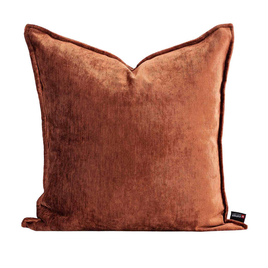 Leather Gallery Vista Plateau Cushion in Burnt Clay, featuring rich rust-brown velvet with piped edges and a branded tag.