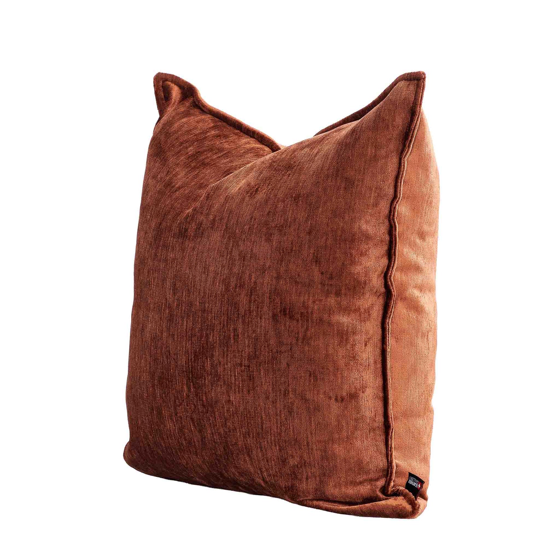 Leather Gallery Vista Plateau Cushion in Burnt Clay, shown at a three-quarter angle with textured rust-brown fabric.