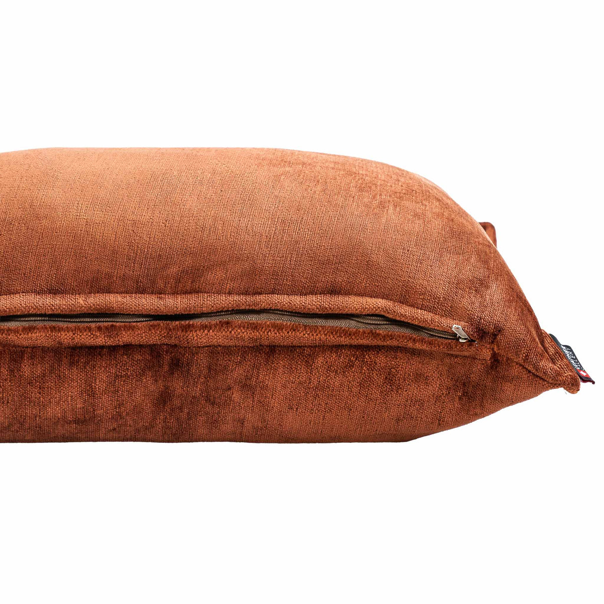 Close-up of the Leather Gallery Vista Plateau Cushion in Burnt Clay, showing textured rust-orange fabric and a zippered closure.