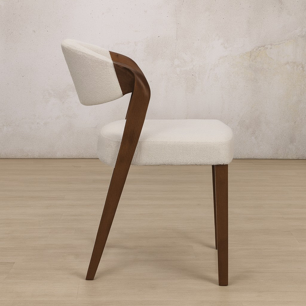 Side view of the Keanu Fabric Walnut Dining Chair showcasing its curved design. | Leather Gallery Dining Chairs, modern dining chairs south africa, dining chairs for round table, fabric dining chairs 