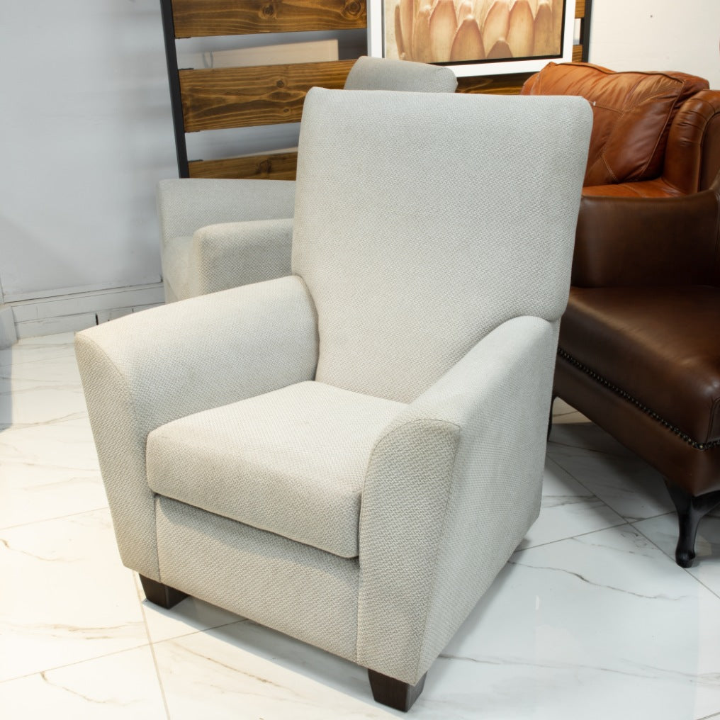 Leather Gallery Lily Occasional Chair, featuring white upholstery styled in a living room with a brown leather sofa and decorative accents.
