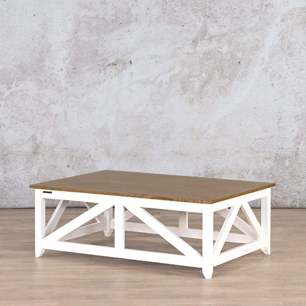 Angled view of the Louvre Wood Coffee Table, highlighting its rustic Oakwood finish and contrasting white base for a modern farmhouse feel.