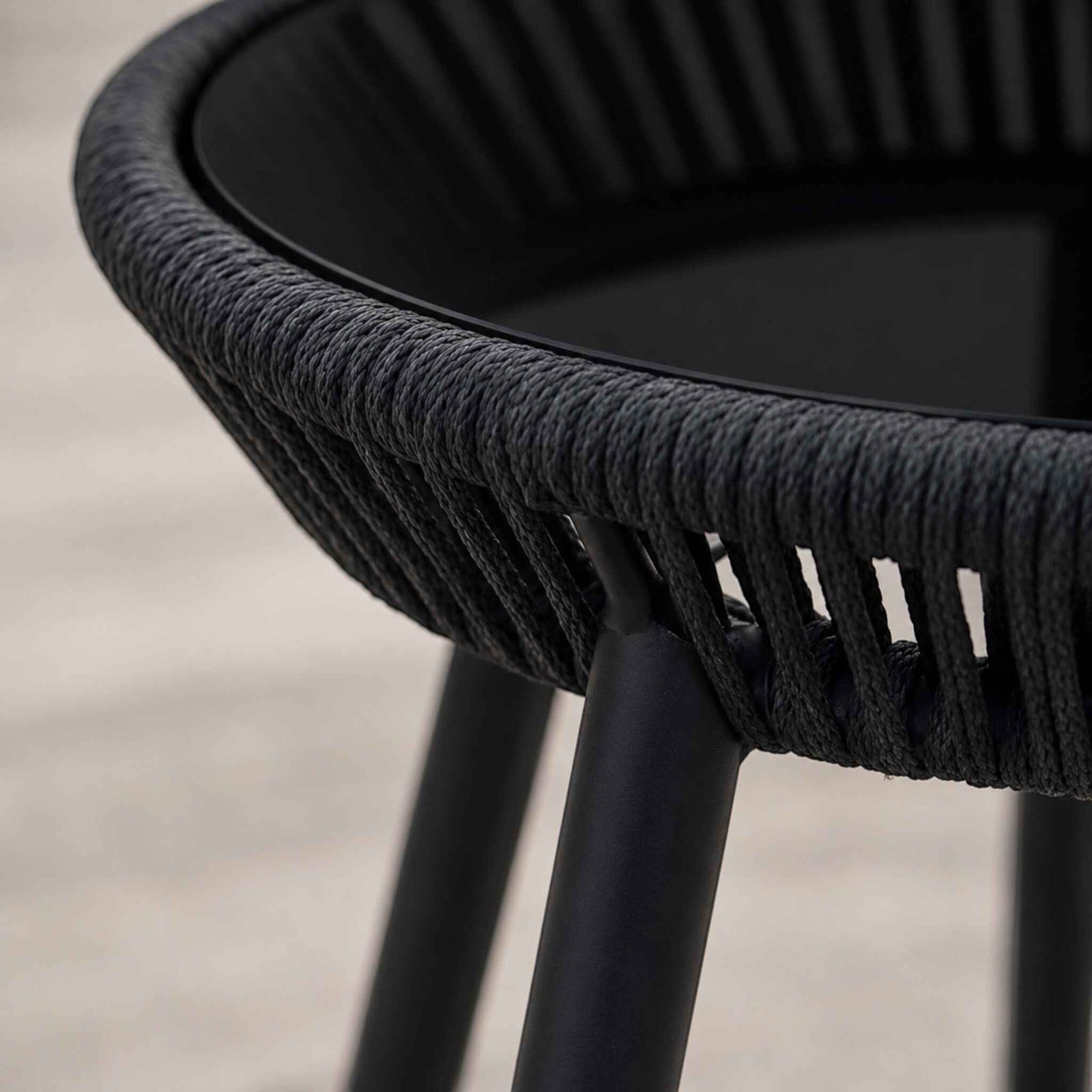 Close up view of the glass top table with a sleek black hued top in the Marlin Patio Set | Outdoor tables, patio furniture, patio set 