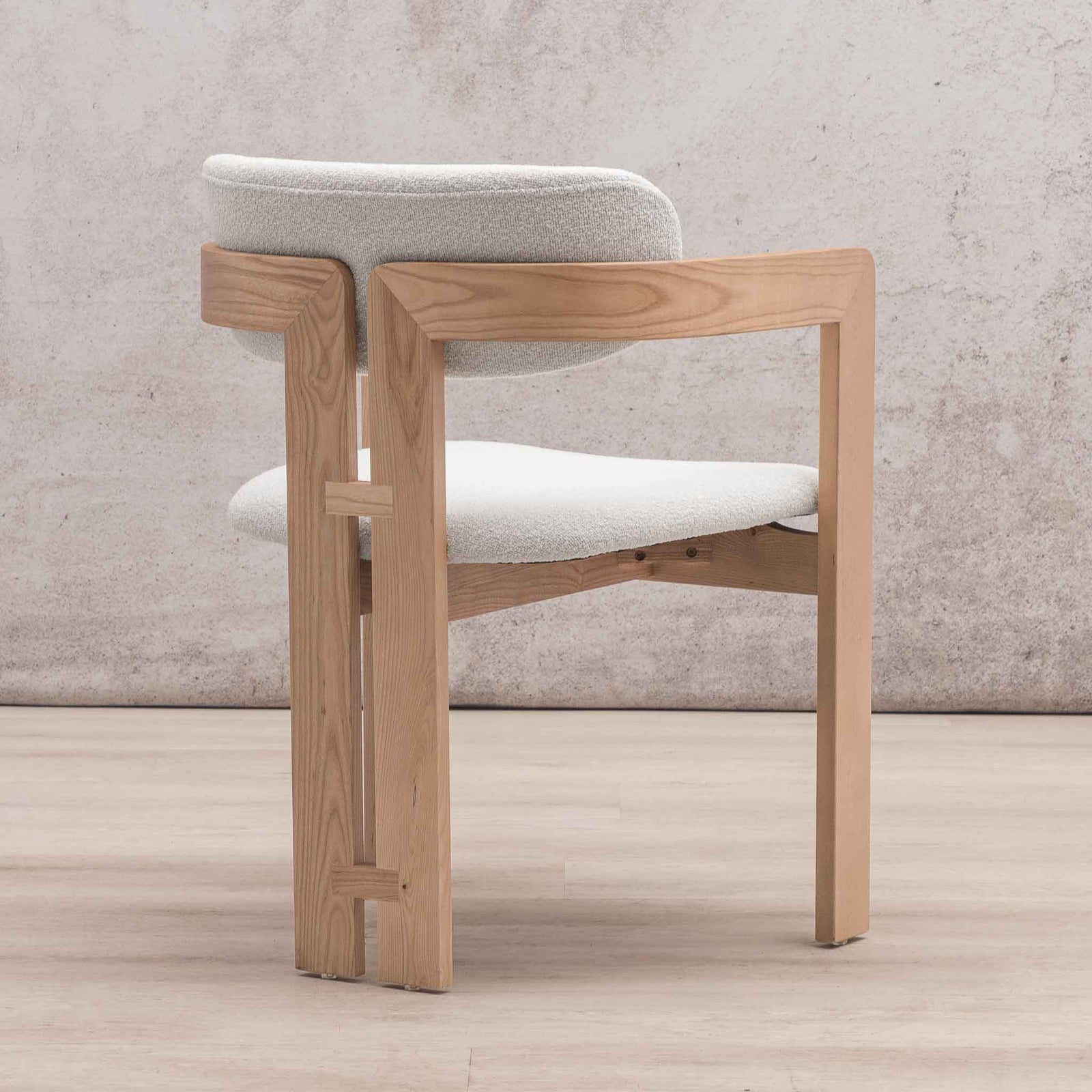 Three-quarter view of Marlon dining chair highlighting geometric wood base and armrests. | wood dining chair, dining chairs south africa, dining chairs