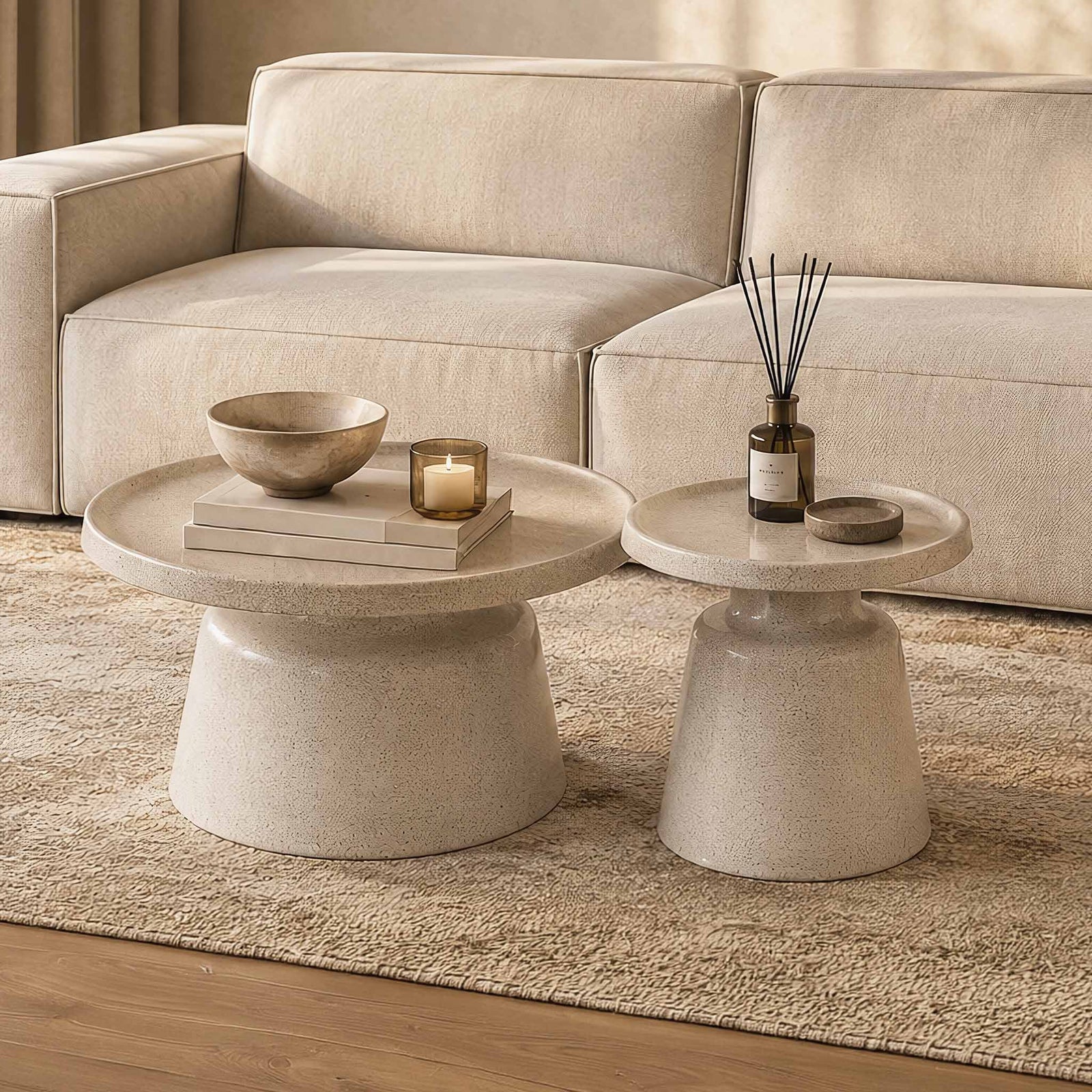 Gallery Everyday Minerva Coffee Tables - White Set of 2, featuring round concrete-look tables styled with neutral décor in a warm living room.