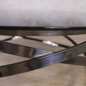 Black glass coffee table featuring a sleek geometric base, ideal for adding style and functionality to any modern living room.