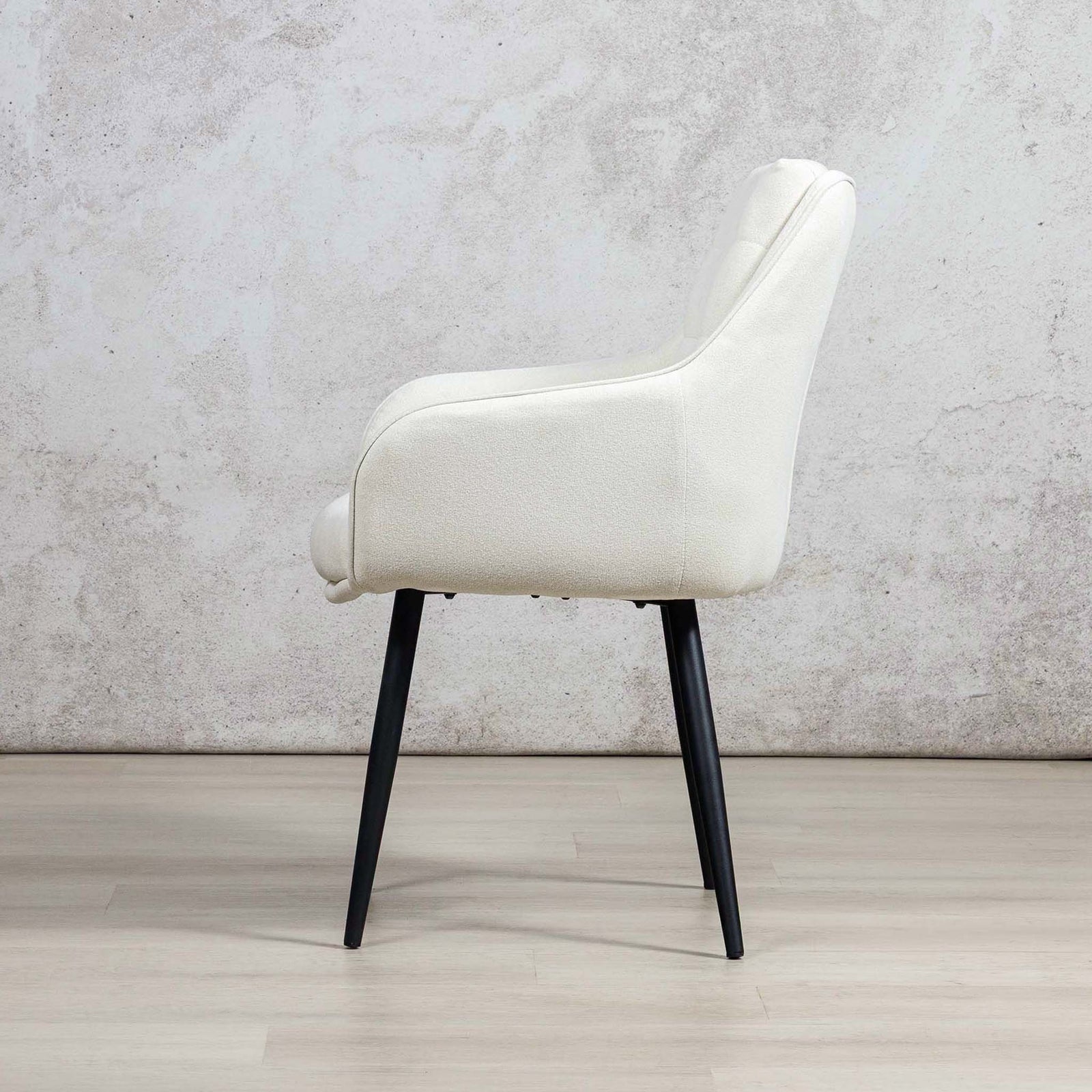 Side profile of Octavia fabric dining chair, in ivory, with high backrest and slender black legs. | dining chairs, modern dining chairs, dining chairs south africa