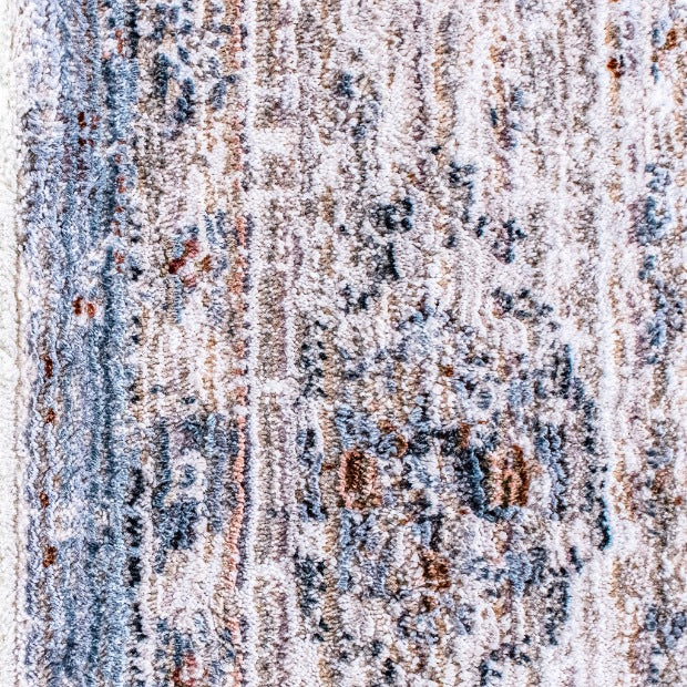 Close-up of the Leather Gallery Persia Hazey Grey Rug, showing its distressed abstract pattern in grey, cream, and warm rust tones.