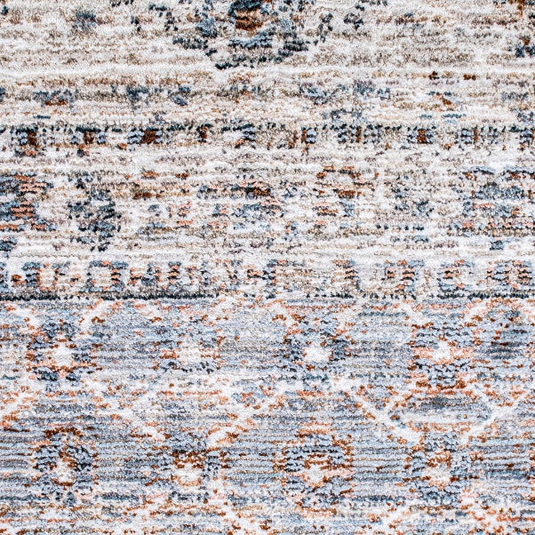 Close-up of the Leather Gallery Persia Hazey Grey Rug, showing its distressed abstract pattern in grey, cream, and warm rust tones.