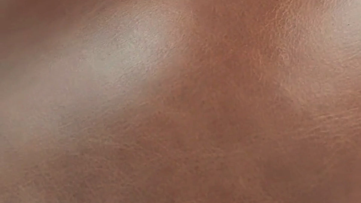 Load video: Slow pan over the new Imperial Royal Walnut leather swatch and close-up details of recliner couches, showcasing its natural grain, rich texture, and finish.