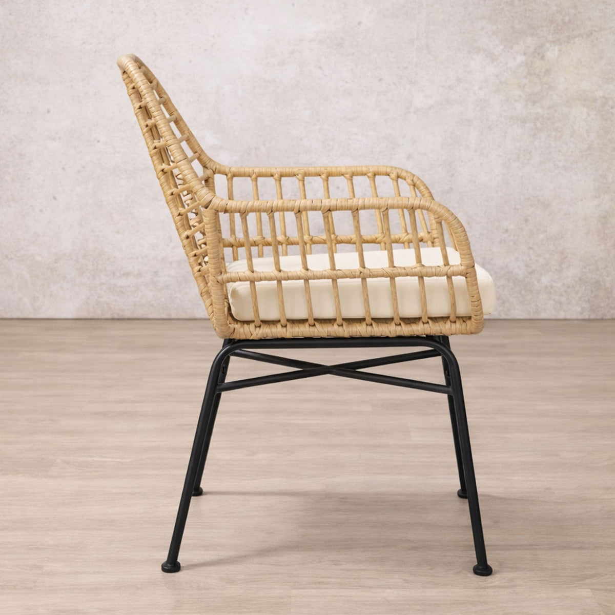 Gallery Everyday Sedona Patio Chairs and Table Set of 3, showing a woven chair with a black metal frame against a textured wall.