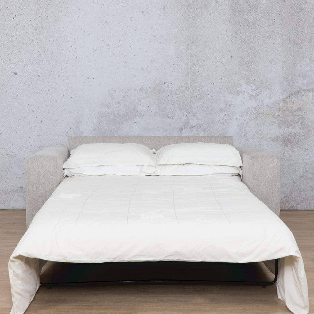 Front view of Leather Gallery’s Stanford fabric sleeper couch set up as a made-up bed for guests, highlighting its dual functionality as a stylish sleeper couch and a comfortable guest bed. Perfect for any home needing a versatile sleeper couch solution. oyster